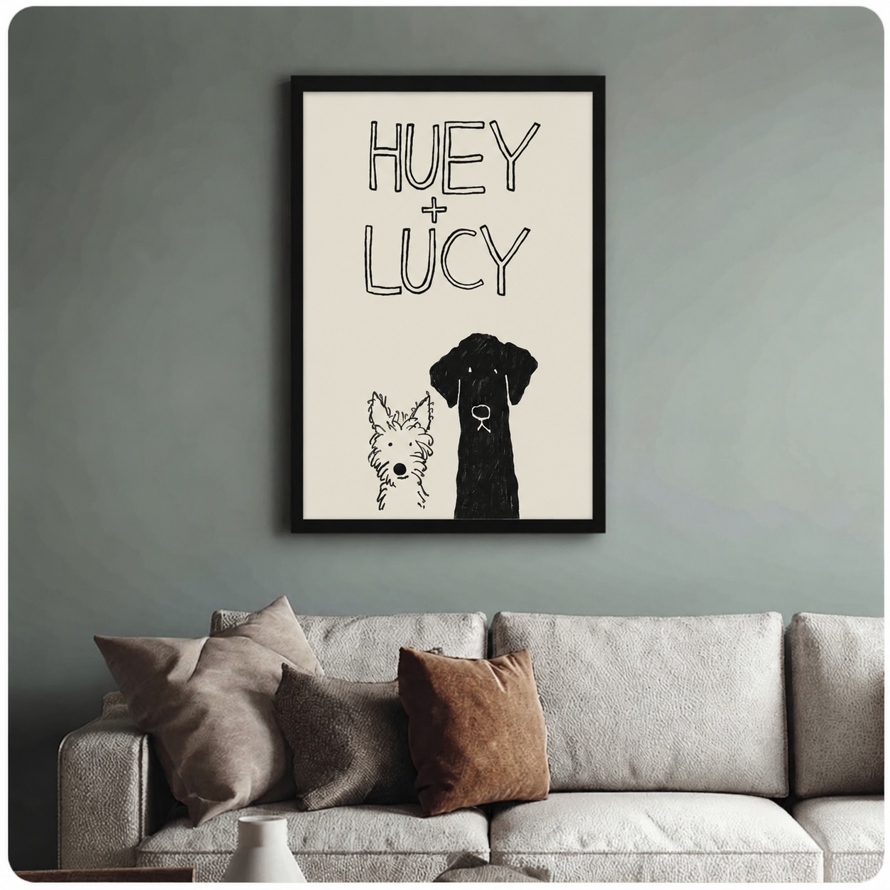 Black framed Huey and Lucy dog sketch wall art print on blue-grey wall above linen sofa