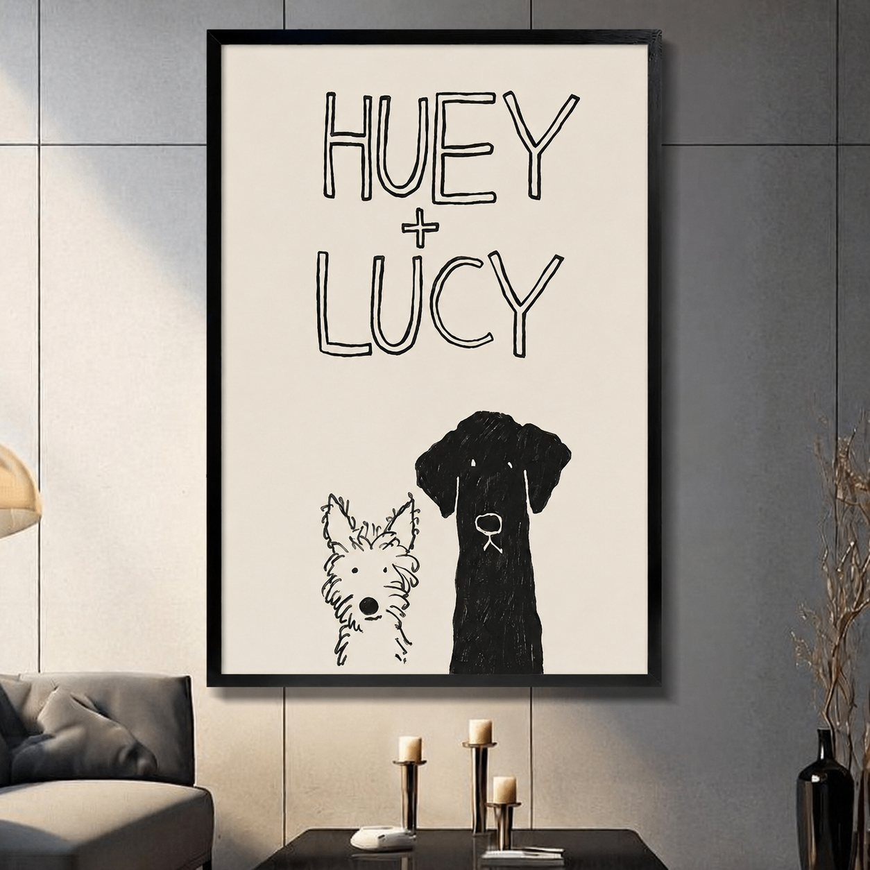 Framed sketch art print of two dogs Huey and Lucy displayed in dark modern living room with candlestick decor