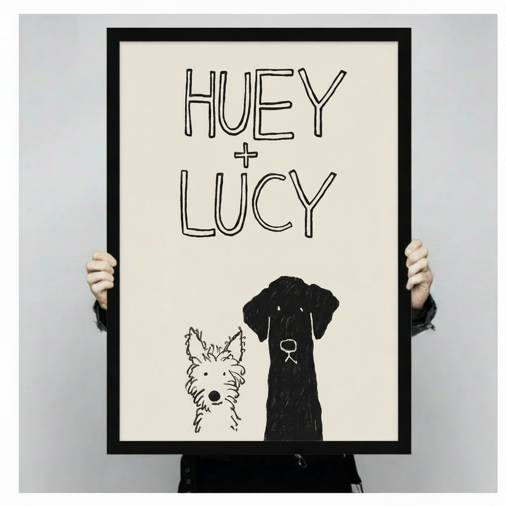 Hand-held black framed Huey and Lucy dog sketch art print showing full artwork size detail and print quality