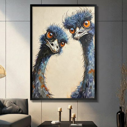 Two emus with wild blue-gray feathers and bright orange eyes peering close together oil painting bird portrait wall art framed print in a living room with gray tiled wall sofa candle holders and black vase