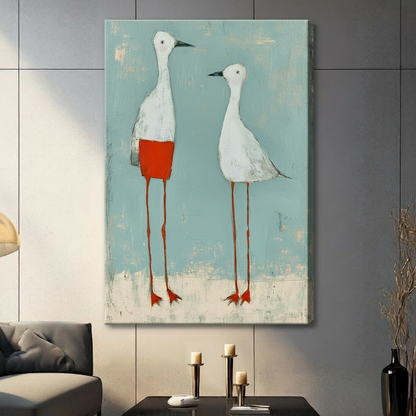 Gallery wrap canvas of two quirky white shorebirds with red legs on a soft teal background, hung in a contemporary living space
