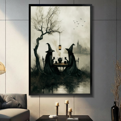 Gothic dark fantasy wall art of two witches in black robes having a tea party by a misty lake under a bare tree with hanging lantern, displayed in black frame on dark gray wall in modern living room