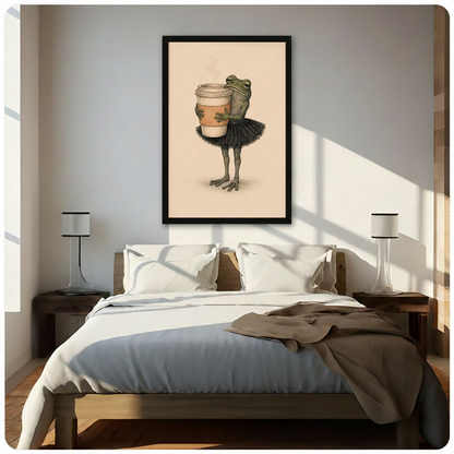 Black framed vintage illustration green frog wearing black ballet skirt hugging oversized coffee cup canvas art on warm beige background above a bed with white linen bedding, a taupe throw blanket, dark wood nightstands, and white cylindrical table lamps in a sunlit modern bedroom