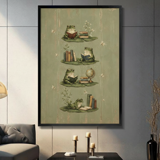 Vintage naturalist illustration of four frogs reading books on lily pads with stacked books, globe, and wildflowers on aged olive green wood grain background framed wall art print displayed in a living room with gray sofa and black decorative vase