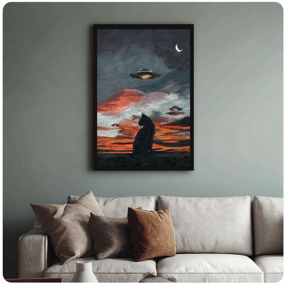 Black cat and ufos black framed canvas above a light sofa in a living room.