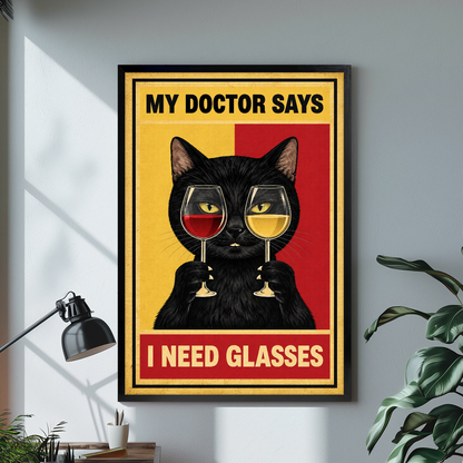 Wine cat artwork with gold border black framed canvas beside a desk lamp and green plant.