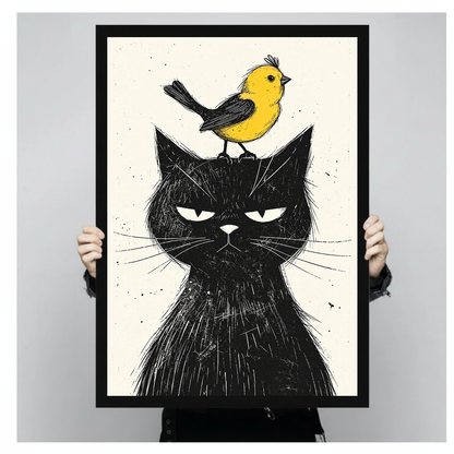 Grumpy black cat with a yellow bird in black framed canvas held by a person.