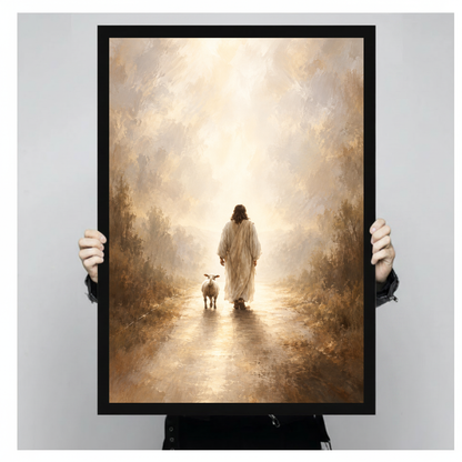 Shepherd and lamb walking toward warm light in black framed canvas held by a person.