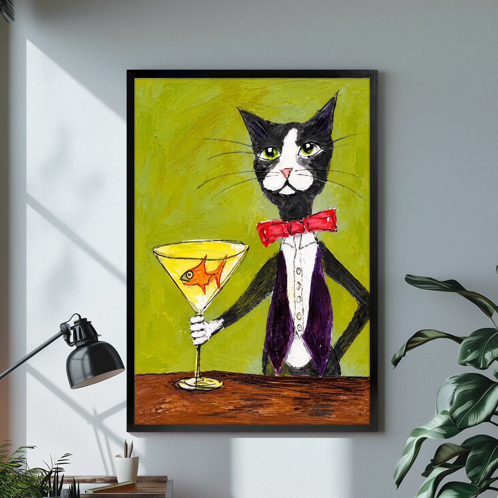 Tuxedo cat holding a goldfish martini glass displayed in black framed canvas beside a lamp.