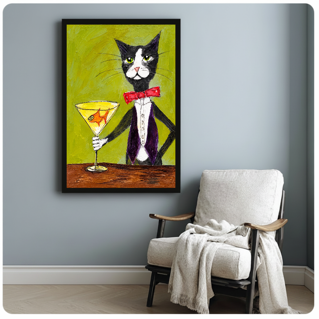 Tuxedo cat holding a goldfish martini glass in framed canvas beside a light armchair.