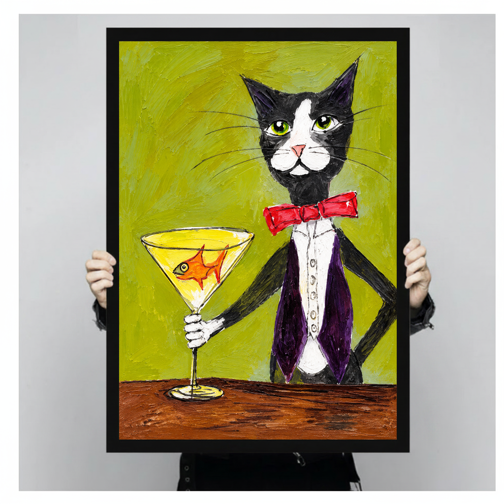 Tuxedo cat holding a goldfish martini glass in black framed canvas held by a person.