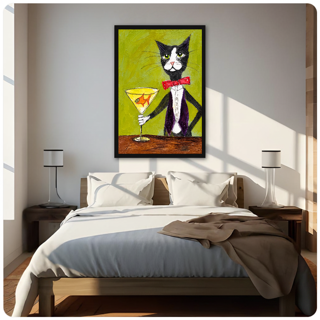 Tuxedo cat holding a goldfish martini glass displayed as framed canvas above a neutral bed.
