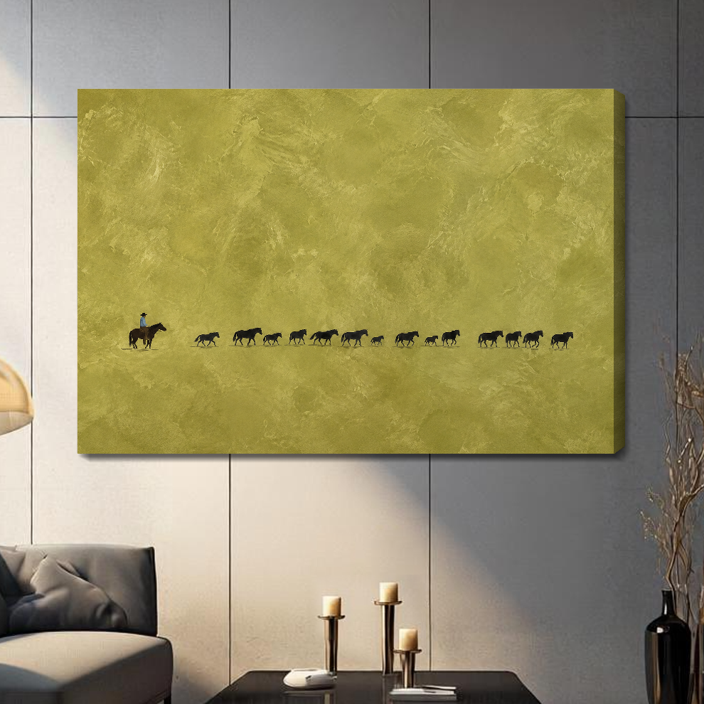 Stretched canvas cowboy and cattle trail artwork with visible side depth against a gray wall.