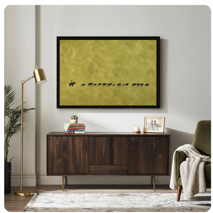 Framed cowboy and cattle trail artwork displayed above a wooden cabinet with decorative accents.