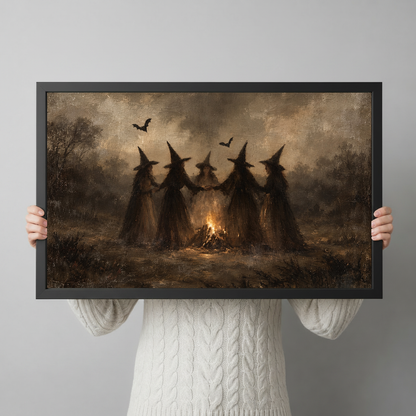 A person holds framed witches around a bonfire artwork to show its horizontal shape and scale.