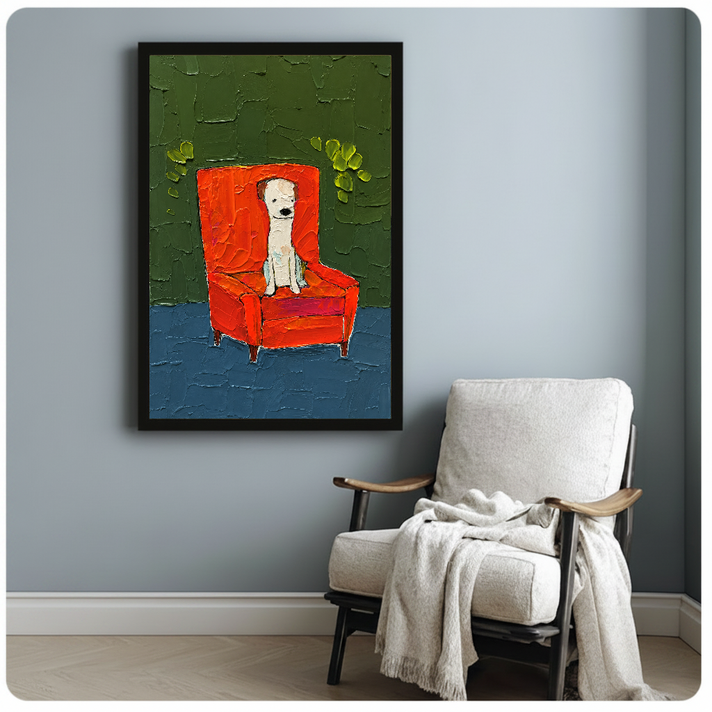 Framed white puppy in red chair canvas art displayed beside a reading chair with a soft blanket.