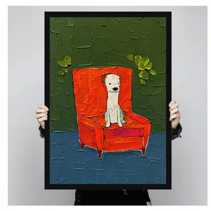A person holds framed white puppy in red chair canvas artwork to show its portrait shape.