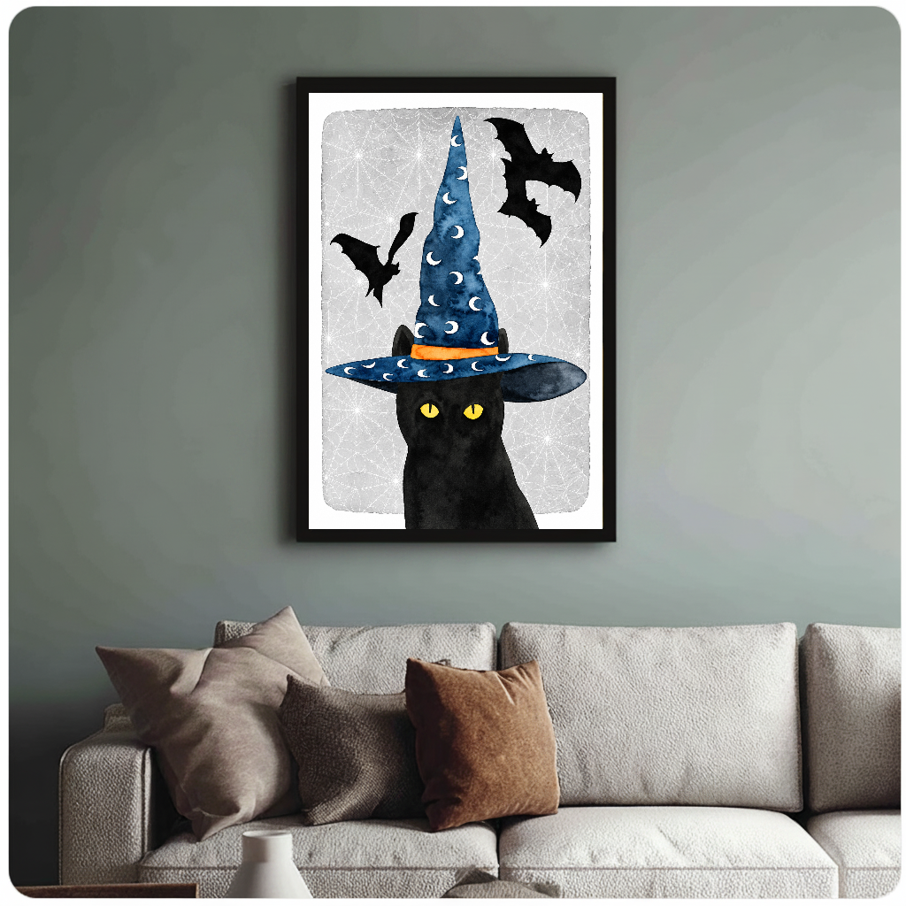 Framed witch cat wall artwork displayed above a neutral sofa with soft cushions.