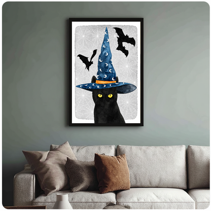 Framed witch cat wall artwork displayed above a neutral sofa with soft cushions.