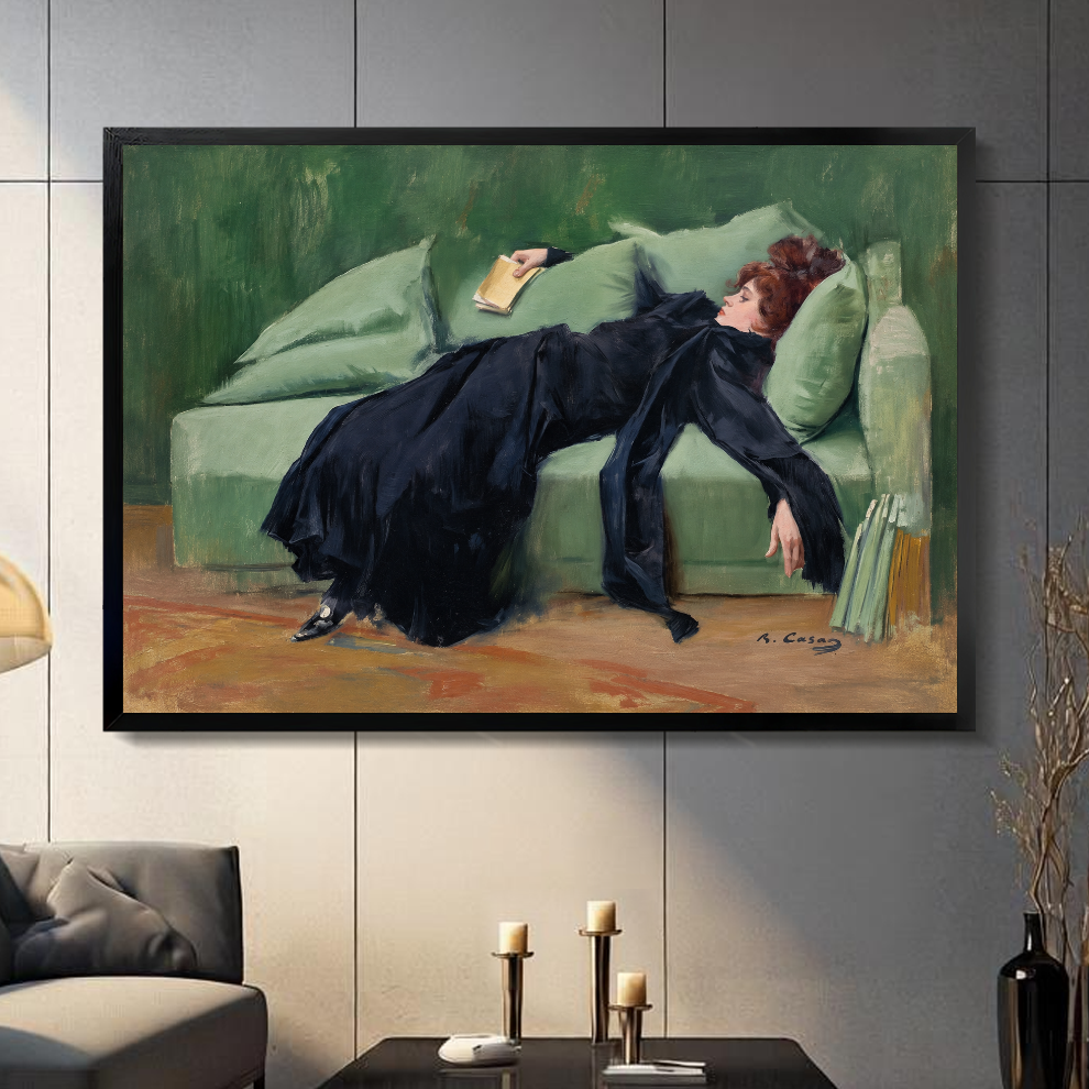 Black framed reading woman canvas artwork displayed in a neutral interior with visible frame depth.