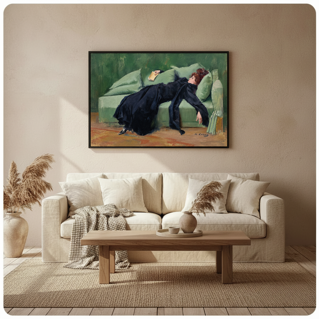 Framed reading woman wall artwork displayed above a neutral sofa in a softly styled room.