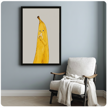 Framed banana character canvas artwork displayed beside a reading chair with a soft blanket.
