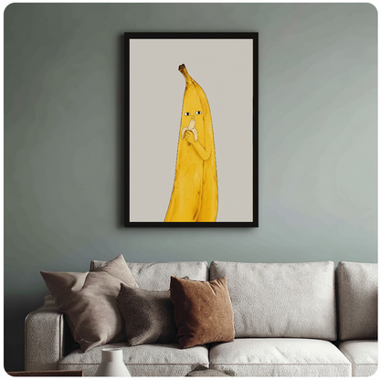 Framed banana character wall artwork displayed above a neutral sofa with soft cushions.