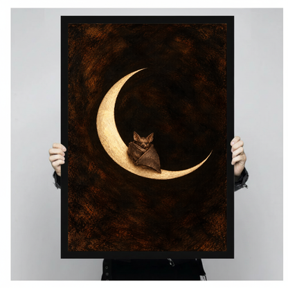 A person holds framed moon bat canvas artwork to demonstrate its portrait proportions.
