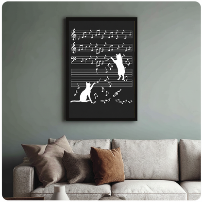 Framed white cat silhouettes and falling music notes displayed above a sofa.