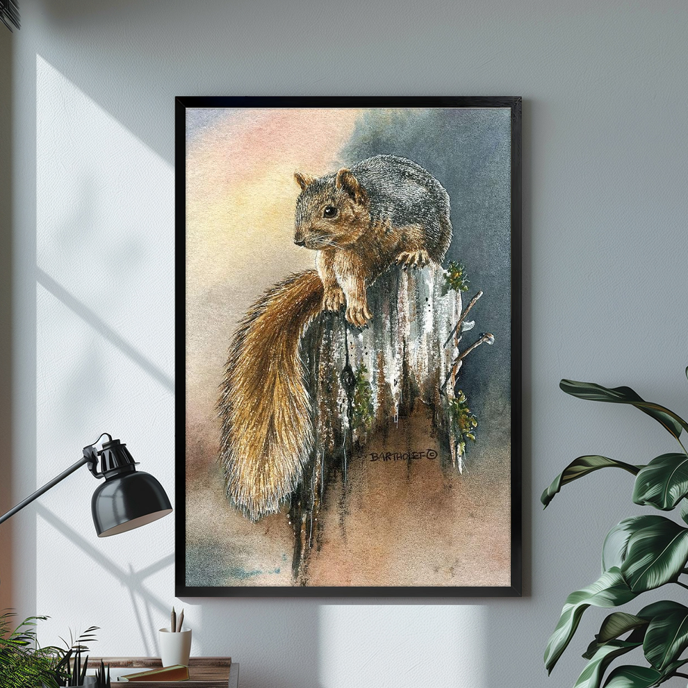 Black framed watercolor squirrel canvas above a bright desk with lamp and green plant.