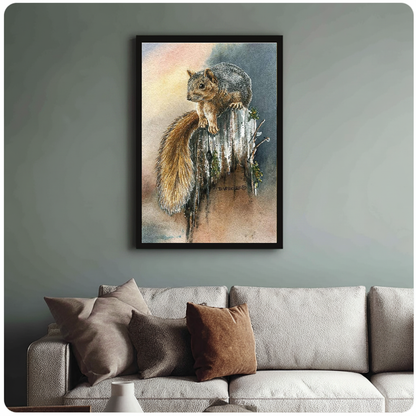 Framed watercolor squirrel painting above a sofa with muted cushions against a green-gray wall.