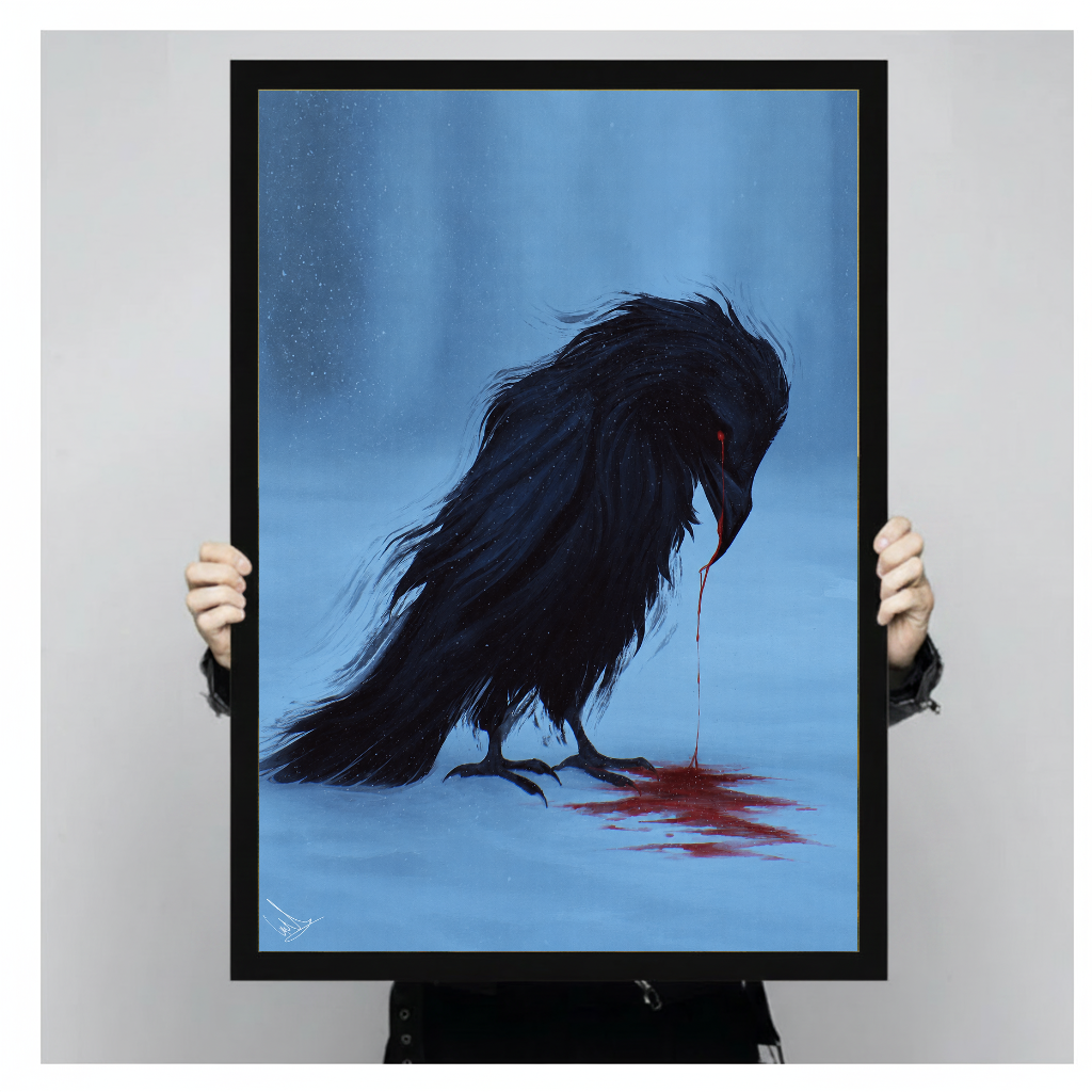 Person holding black framed blue grieving raven artwork against a plain pale background.