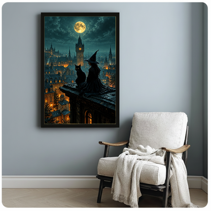 Framed artwork of a witch and black cat beneath moonlight beside a pale reading chair against a gray wall.