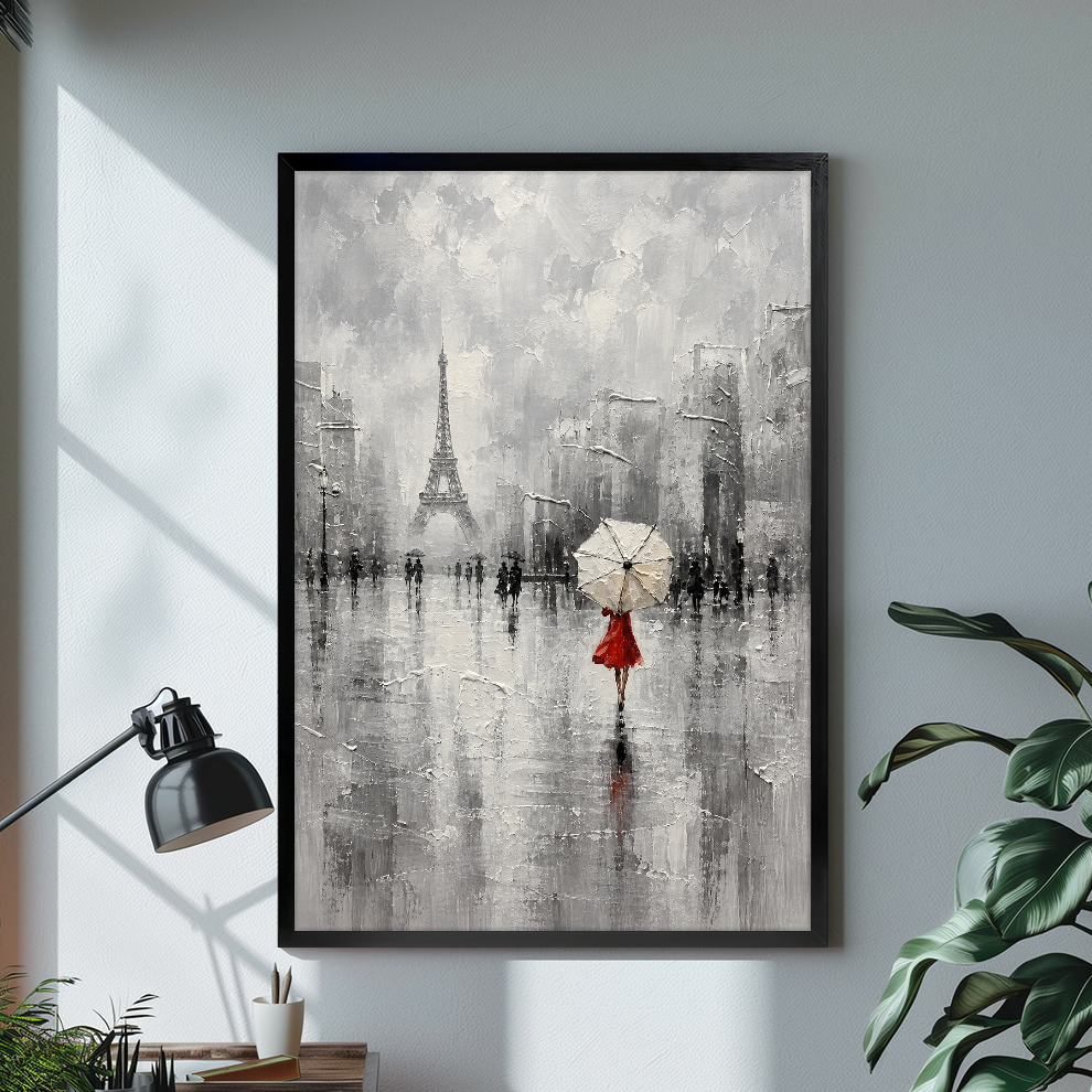 Black framed canvas depicting a red dressed woman beneath an umbrella on a bright desk with a lamp.