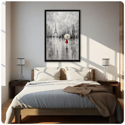 Framed artwork of a red dressed woman beneath an umbrella above a neutral bed between two bedside lamps.