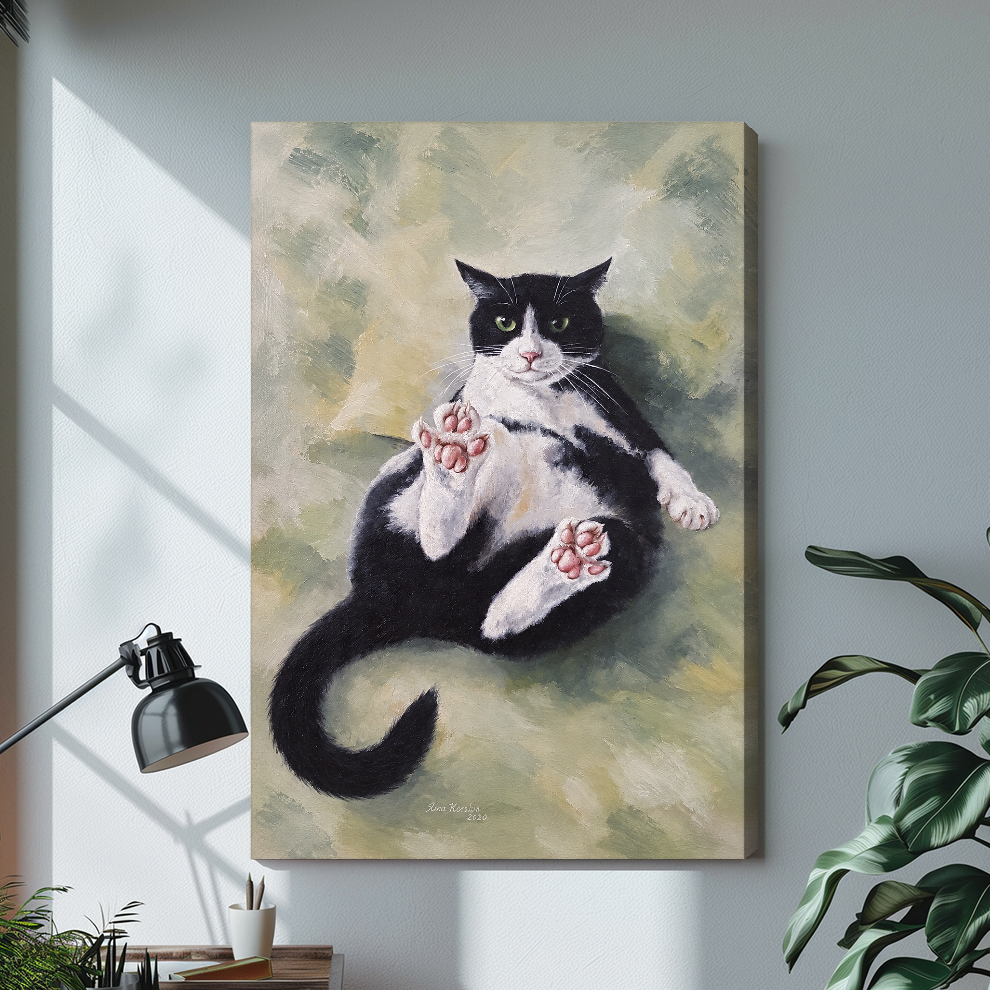 Stretched relaxed tuxedo cat canvas above a light desk, showing a shaded wrapped side edge.
