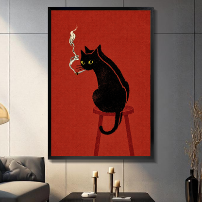 Black framed smoking black cat canvas above a console beside a sofa in a paneled room.