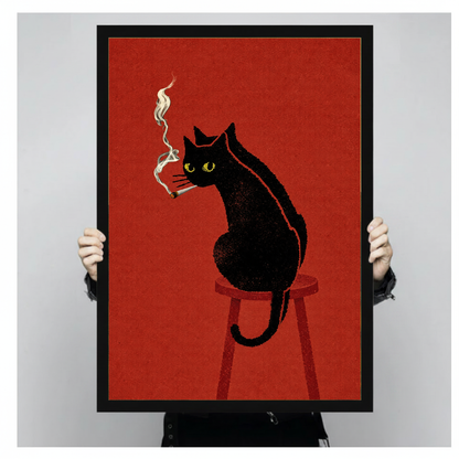 Person holding black framed smoking black cat artwork against a plain pale background.