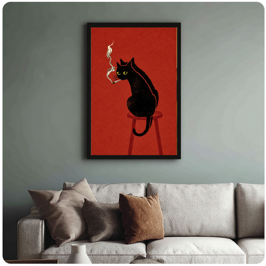 Framed smoking black cat painting above a sofa with muted cushions against a green-gray wall.