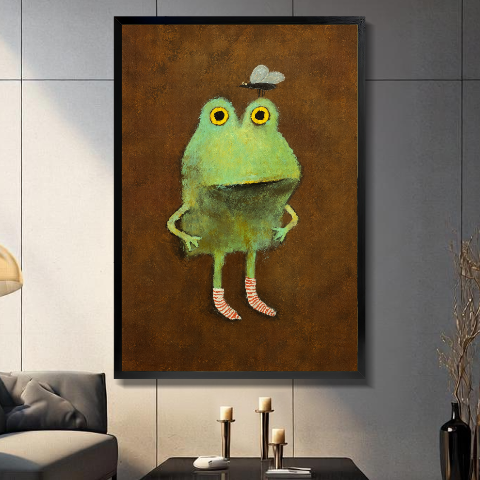 Black framed canvas depicting a green frog wearing striped socks on a gray paneled wall with candles.