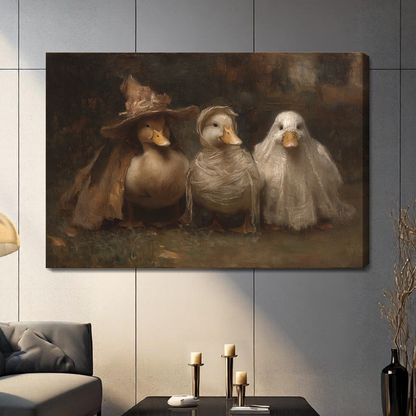 Stretched canvas depicting three ducks wearing Halloween costumes displayed on a gray paneled wall with candles.