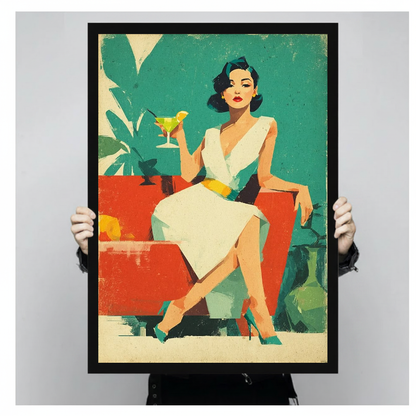 Person holding black framed retro cocktail woman artwork against a plain pale background.
