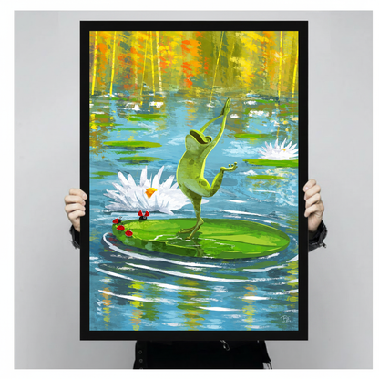Person holding black framed dancing pond frog artwork against a plain pale background.
