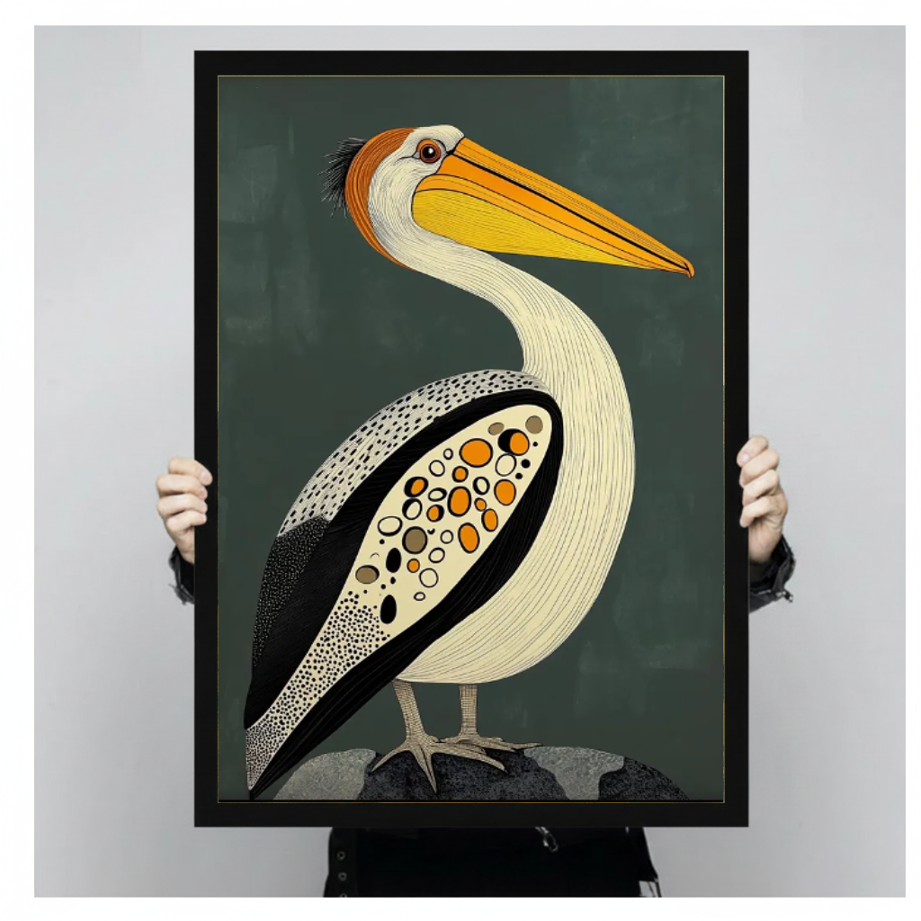 Framed artwork of a patterned pelican with a golden bill held by a person against a pale backdrop.