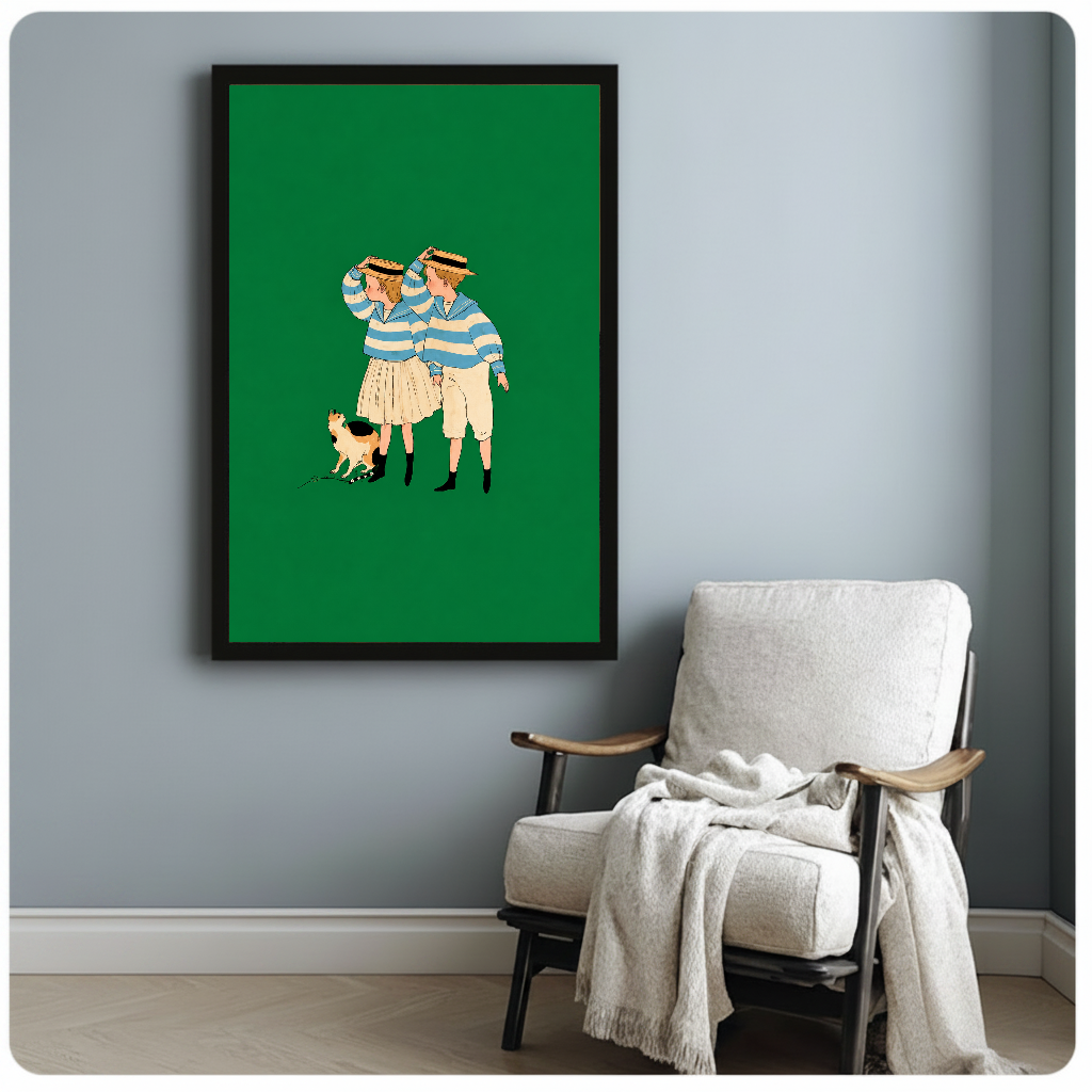 Framed artwork of two striped companions and a calico cat beside a pale reading chair against a gray wall.