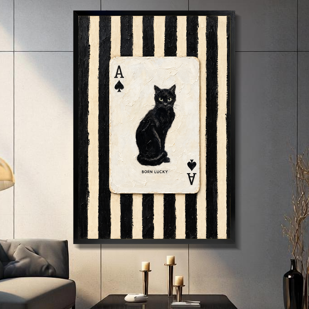 Black framed canvas depicting a black cat inside an ace playing card on a gray paneled wall with candles.