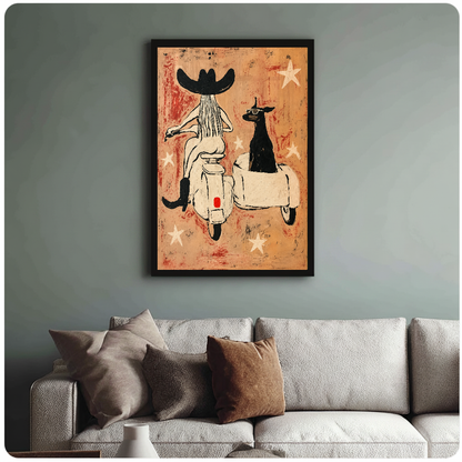 Framed cowgirl scooter dog painting above a sofa with muted cushions against a green-gray wall.