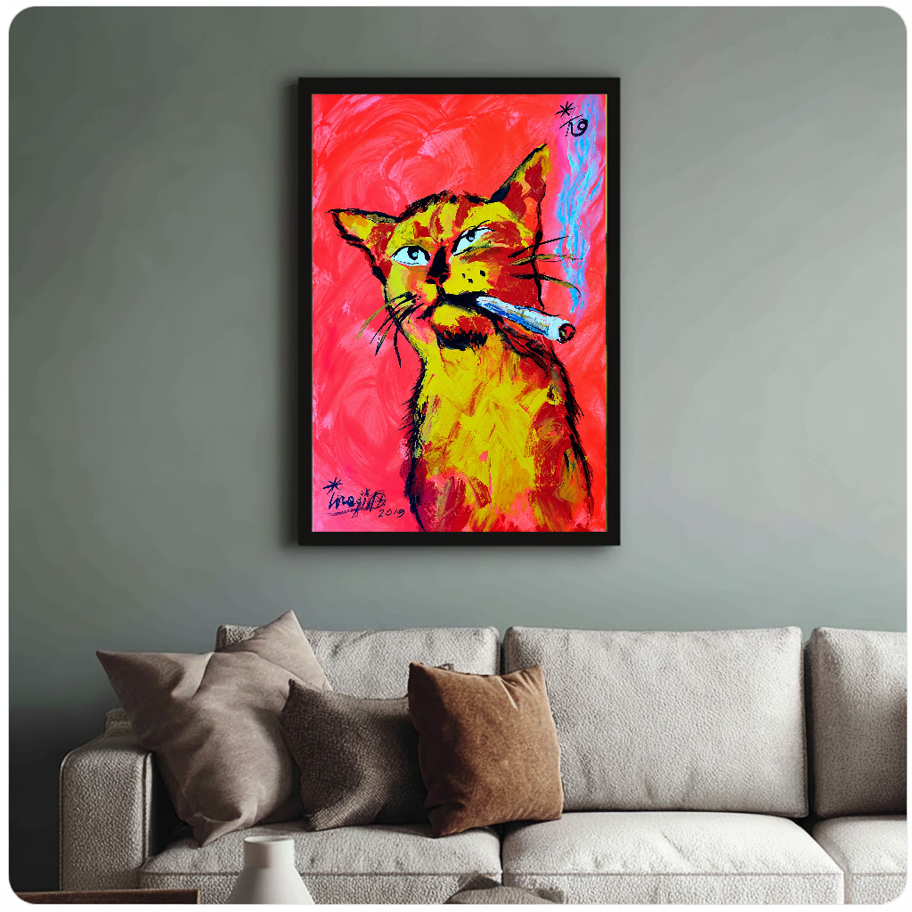 Framed neon cigar cat painting above a sofa with muted cushions against a green-gray wall.
