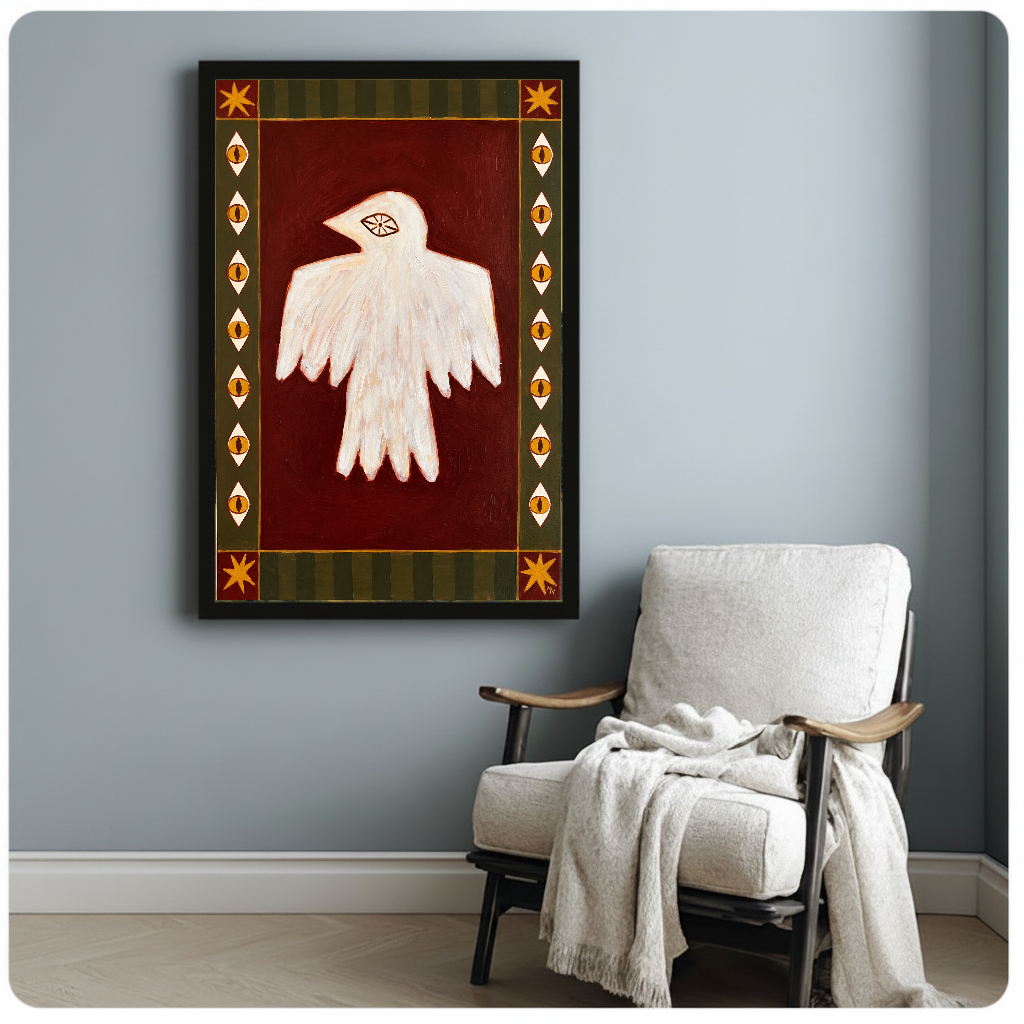 Framed folk bird with eyes artwork beside a pale reading chair against a blue-gray wall.