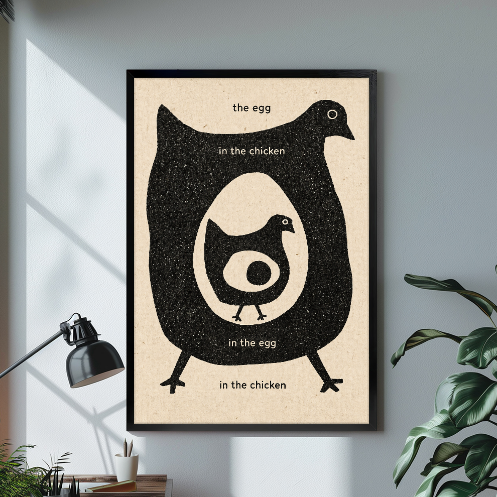 Black framed canvas depicting a chicken and egg question on a bright desk with a lamp.